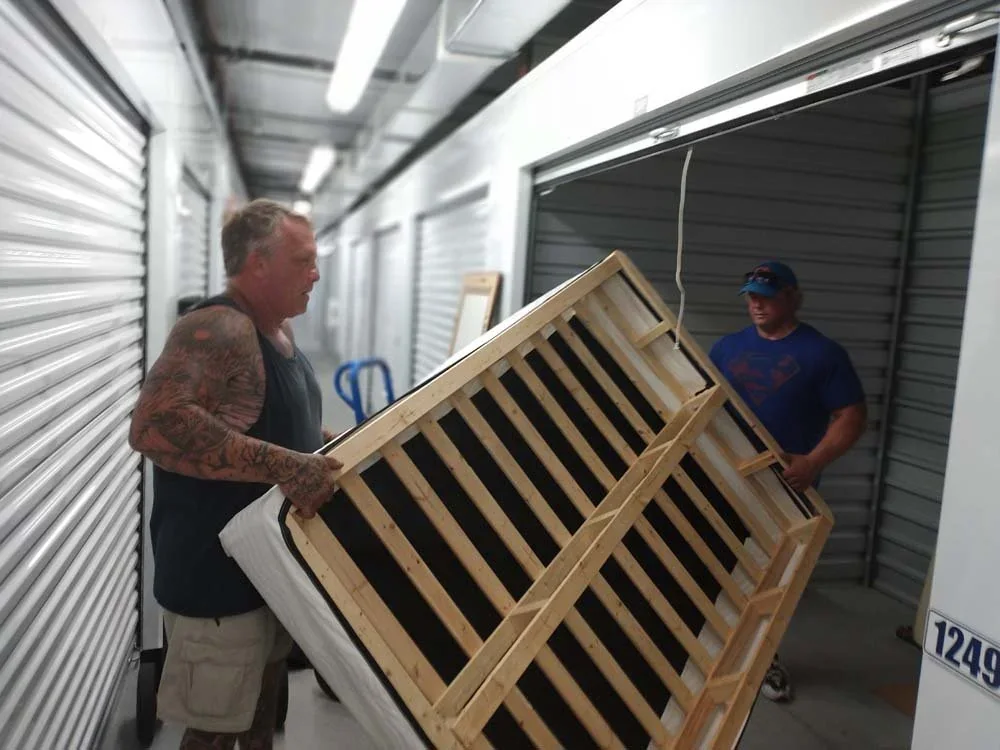 Crew loading bulky items into the truck during a cleanout